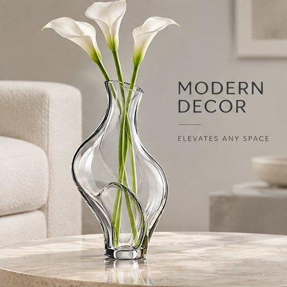 Clear crystal glass wave vase with white calla lilies on a marble round coffee table in a modern living room