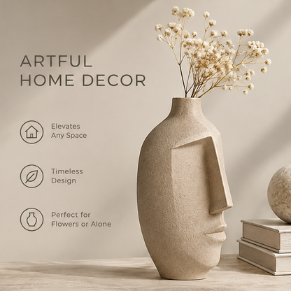 Artful home decor view of the sandy beige face vase with baby's breath dried flowers beside books and a stone sphere