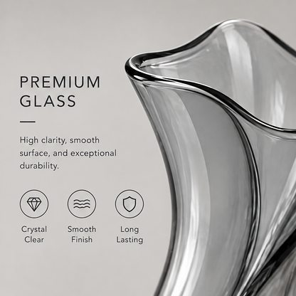 Smoke grey glass tulip vase with white roses on a marble surface in warm natural light showing simple beauty for every space